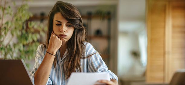 Woman looks confused while reviewing benefits