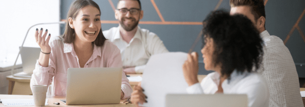 Coworkers talk at table