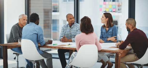 Group of employees at conference table. 