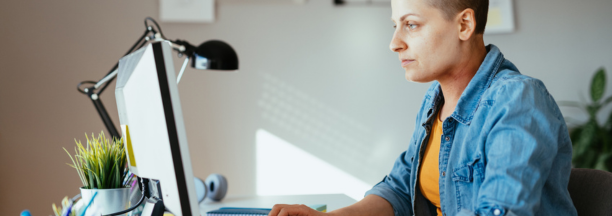 Employee with cancer on her laptop.