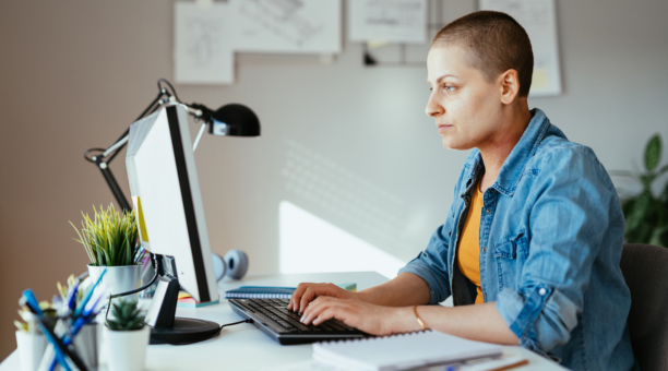 Employee with cancer on her laptop.