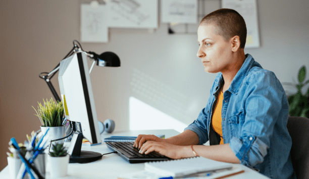 Employee with cancer on her laptop.
