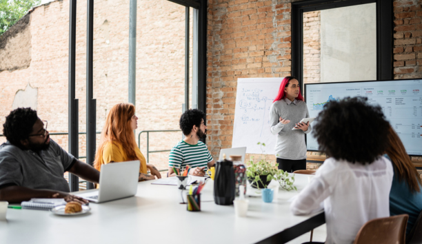 Group of diverse employees working together in a conference room.