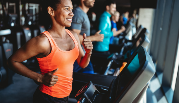 woman jogging on treadmill in gym